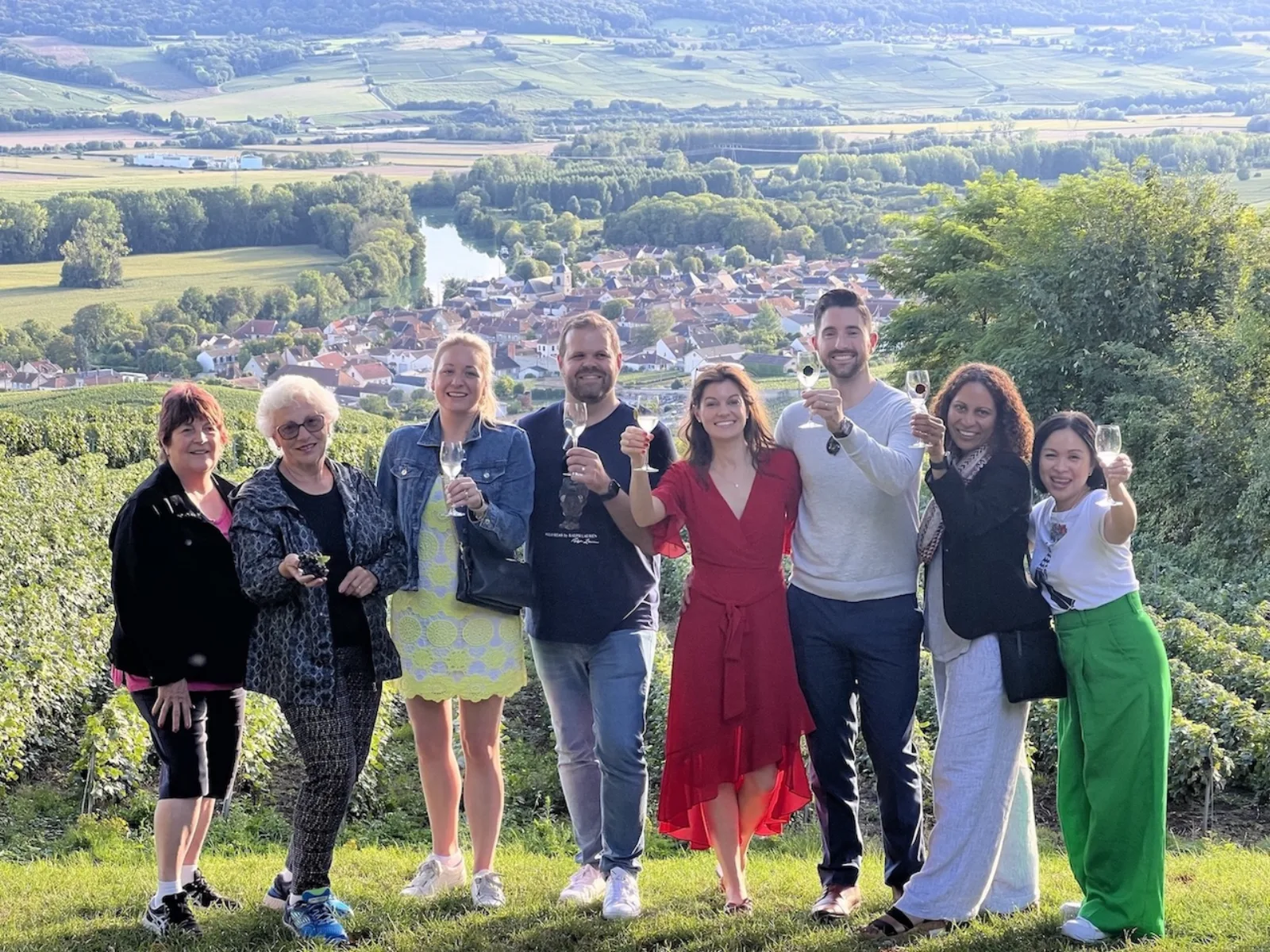 The group posing on a vineyard slope above a village in the Marne valley